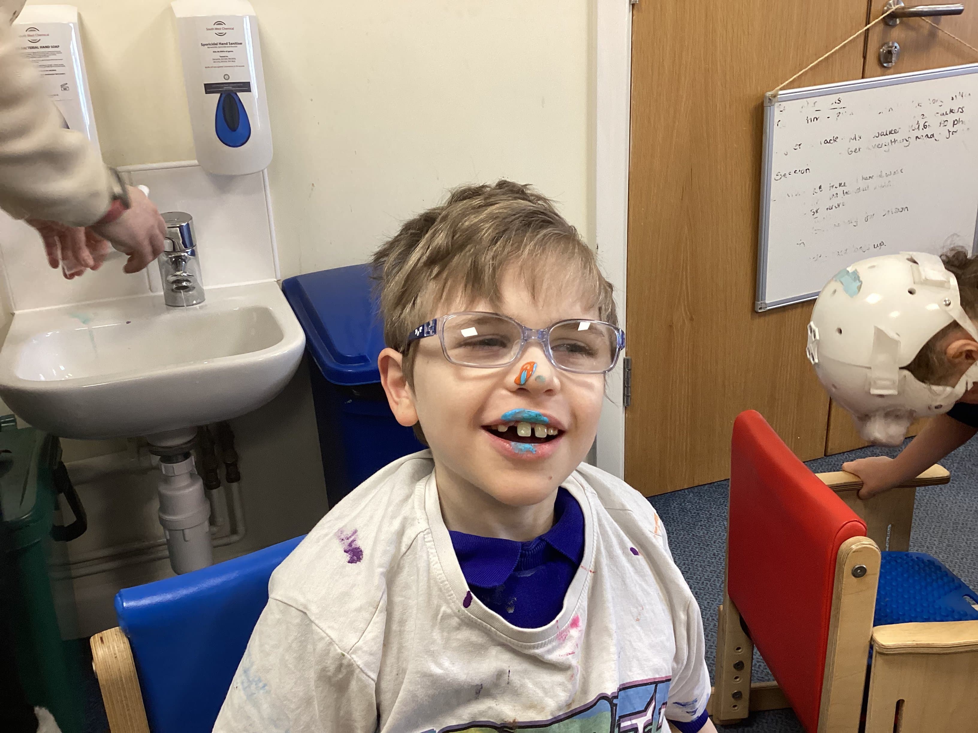 Boy enjoying messy paint play