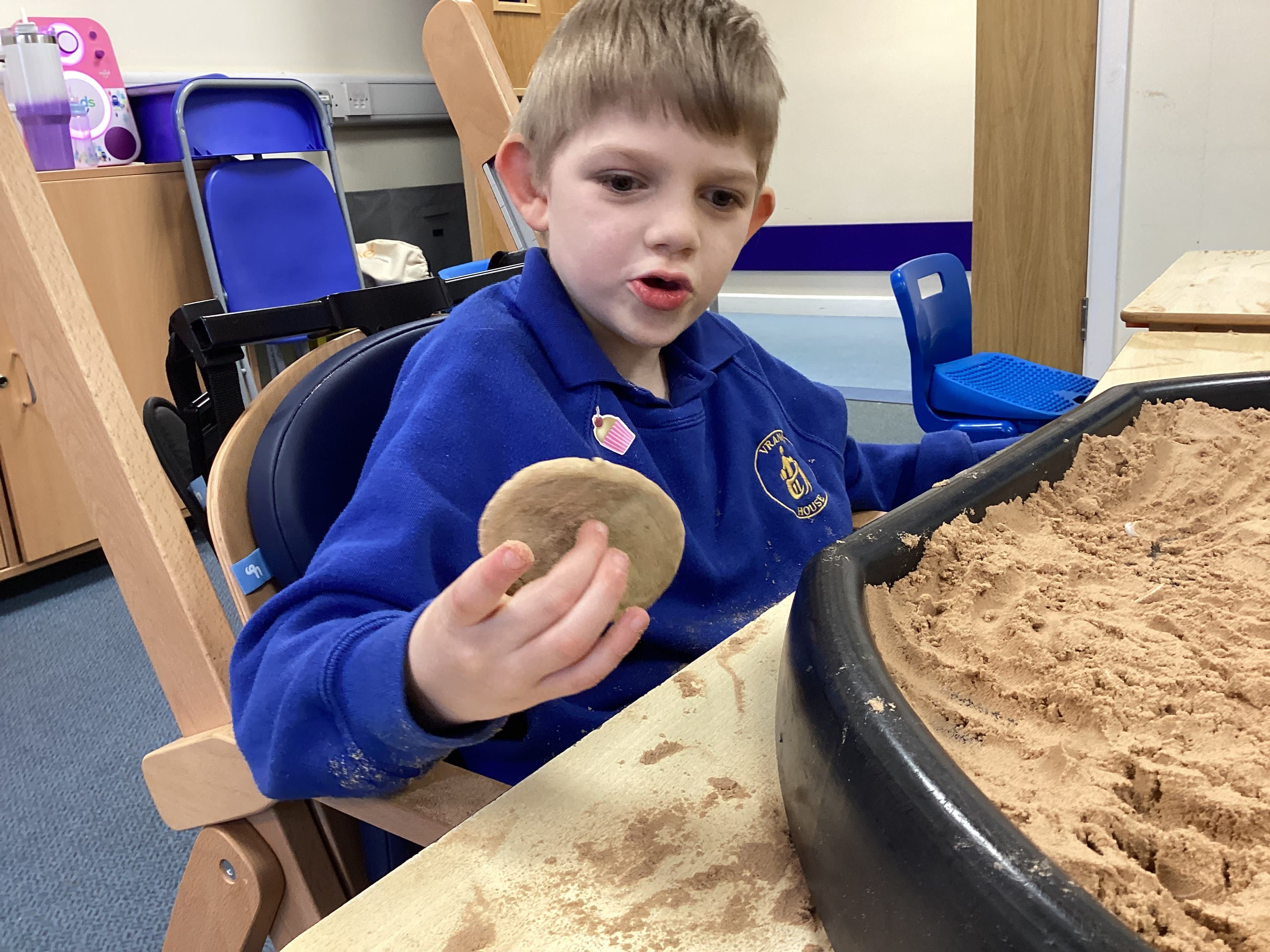 Boy exploring sensory sand play